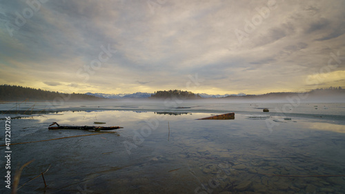 Fog above lake Ostersee in Winter at sunset