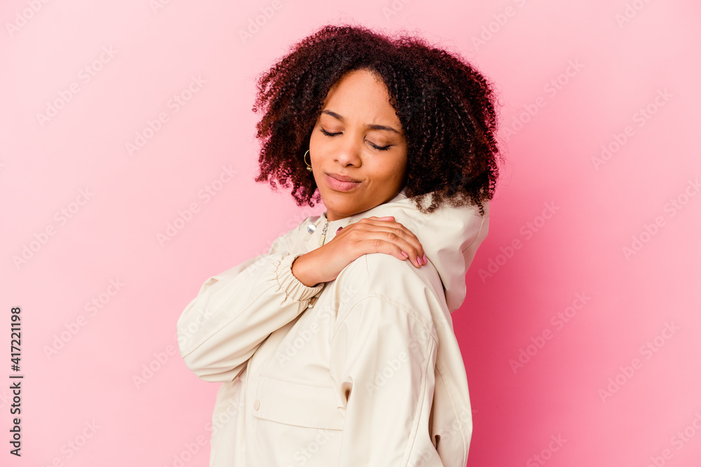 Young african american mixed race woman isolated having a shoulder pain. Young african american mixed race woman isolated having a shoulder pain.