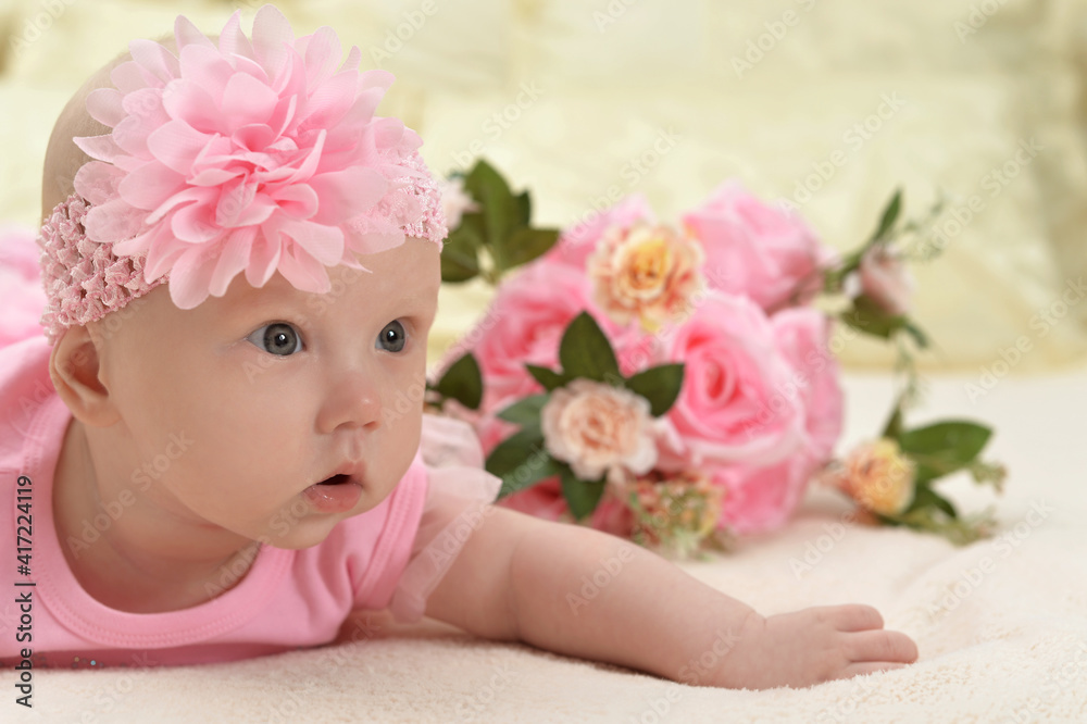 cute little baby girl on bed with flowers cute little baby girl on bed with flowers