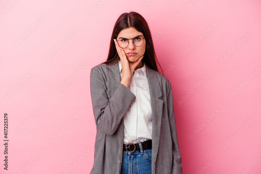 Young caucasian business woman isolated on pink background who is bored, fatigued and need a relax day. Young caucasian business woman isolated on pink background who is bored, fatigued and need a relax day.