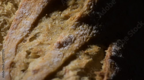 Detail of crusty bread with an intimate light, rotation photo