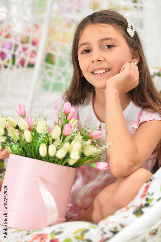 happy little girl posing with tulips on swing happy little girl posing with tulips on swing