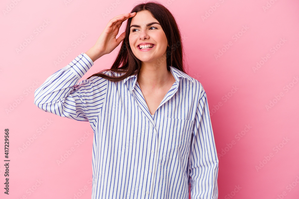Young caucasian woman isolated on pink background joyful laughing a lot. Happiness concept.