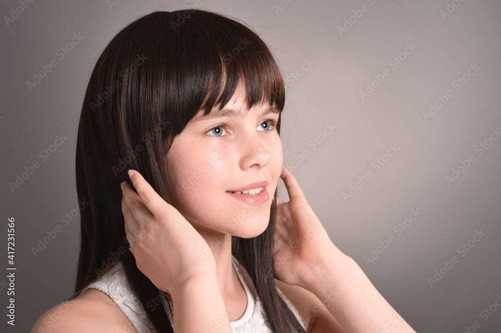 Cute happy girl with dark hair posing Cute happy girl with dark hair posing