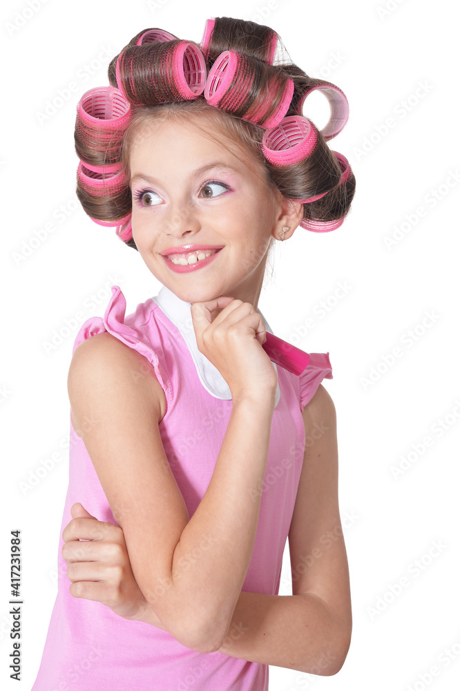 portrait of emotional little pretty girl with hair curlers