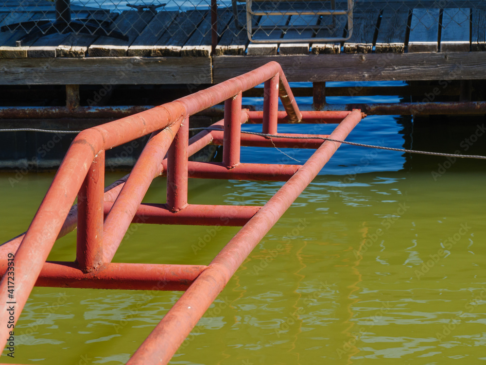 Floating Dock Held in Place with Old Red Metal Structure Floating Dock Held in Place with Old Red Metal Structure