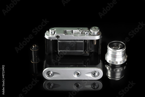 The rare old rangefinder film camera on black glass background.