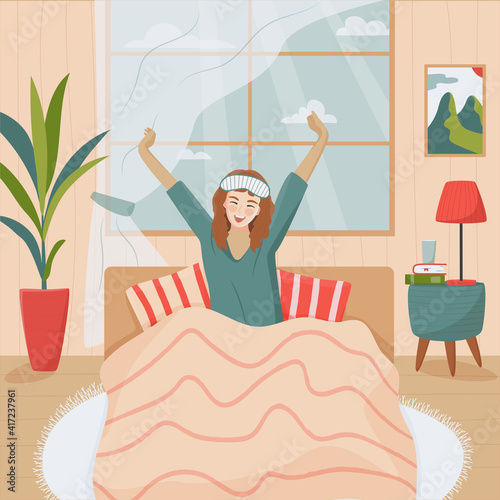 Young happy woman in sleep mask stretching her arms and smiling  after waking up. Good morning concept. Smiling positive woman awaken in comfortable bedroom feel optimistic welcome new day