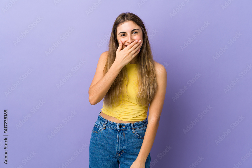 Young woman over isolated purple background happy and smiling covering mouth with hand Young woman over isolated purple background happy and smiling covering mouth with hand