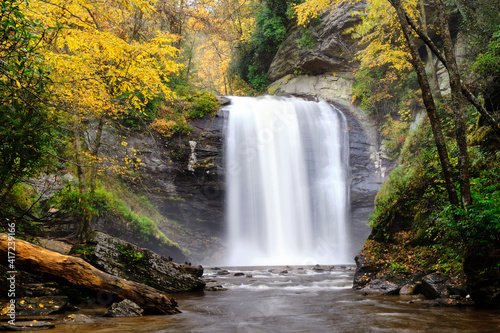 Looking glass falls in North Carolina. It is autumn, so the falls is surrounded by colorful trees. 