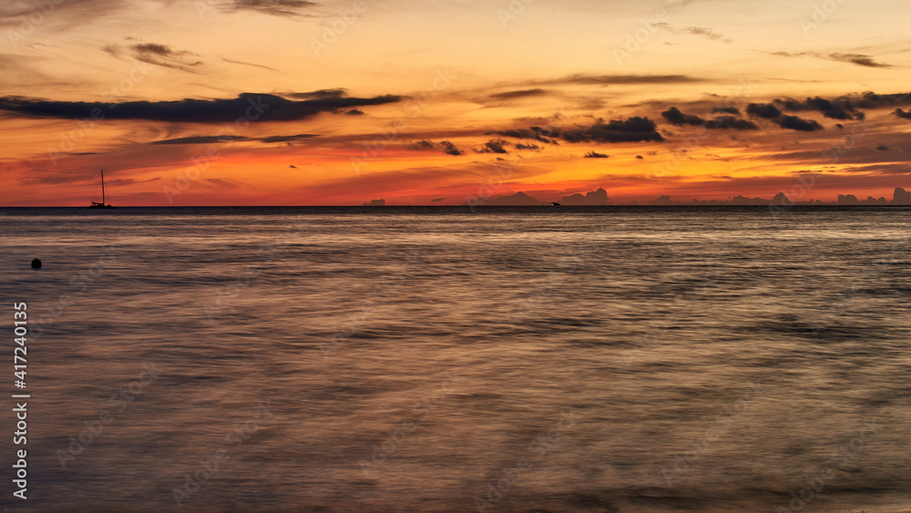 Cuba. Trinidad. Ancon. Flame of the sunset over the water surface