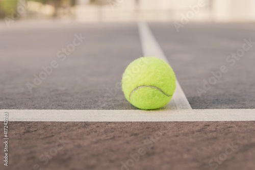 Green tennis ball on court line. Tennis game, active sport, recreation and wellbeing concept