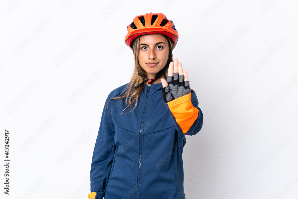 Young hispanic cyclist woman isolated on white background making stop gesture
