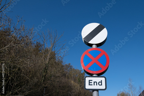 Road sign in the UK advising drivers that the national speed limit applies to that stretch of road and that drivers may now stop at the roadside