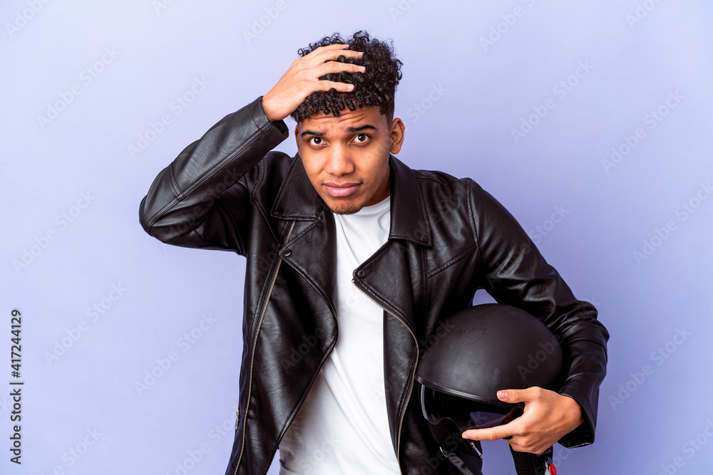 Young african american curly biker man isolated being shocked, she has remembered important meeting. Young african american curly biker man isolated being shocked, she has remembered important meeting.