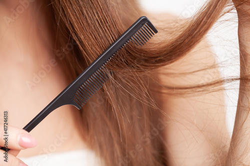 Woman with a comb in her hand on dressing room.