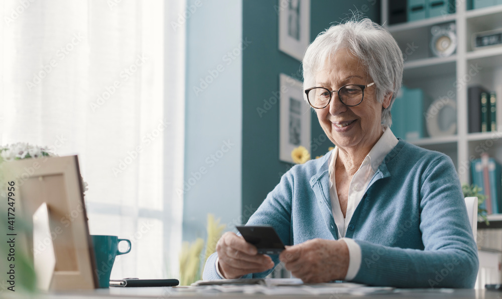 © StockPhotoPro - Happy senior lady going through old pictures © StockPhotoPro - Happy senior lady going through old pictures