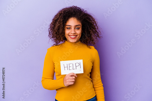 Young African American woman holding a Help placard isolated on purple background happy, smiling and cheerful.