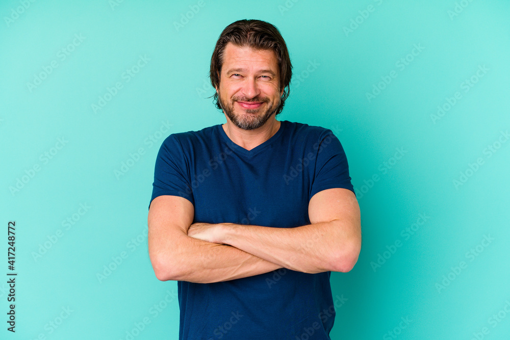 Middle age man standing isolated on blue background Middle age man standing isolated on blue background