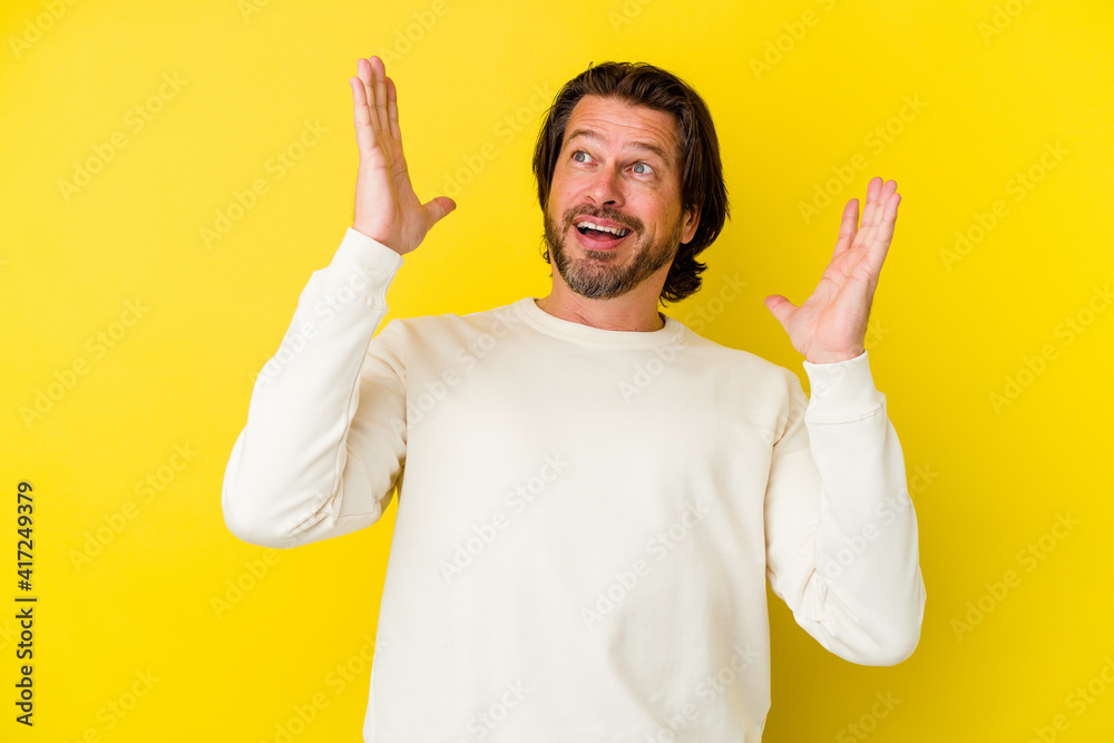 Middle age caucasian man isolated on yellow background screaming to the sky, looking up, frustrated. Middle age caucasian man isolated on yellow background screaming to the sky, looking up, frustrated.