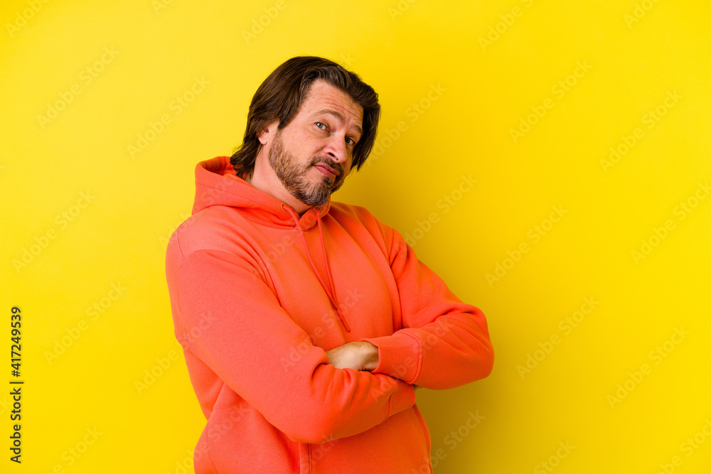 Middle age caucasian man isolated on yellow background unhappy looking in camera with sarcastic expression. Middle age caucasian man isolated on yellow background unhappy looking in camera with sarcastic expression.
