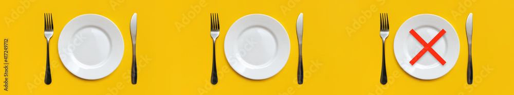 On the yellow tablecloth are three sets of white empty plates,stainless steel forks and knives.There is a red cross at the place of Dinner.Minimum serving.Intermittent fasting, diet.Copy space, mockup On the yellow tablecloth are three sets of white empty plates,stainless steel forks and knives.There is a red cross at the place of Dinner.Minimum serving.Intermittent fasting, diet.Copy space, mockup