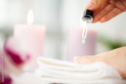 Applying medicated oil to the toenail to strengthen the nail plate and age the nail fungus.