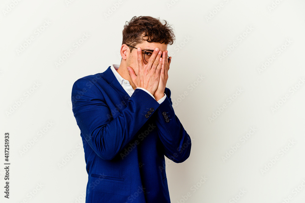 Young business caucasian man isolated on white background blink through fingers frightened and nervous. Young business caucasian man isolated on white background blink through fingers frightened and nervous.