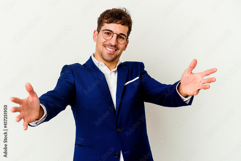 Young business caucasian man isolated on white background feels confident giving a hug to the camera. Young business caucasian man isolated on white background feels confident giving a hug to the camera.