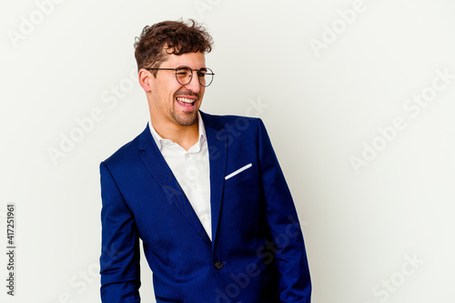 Young business caucasian man isolated on white background laughs and closes eyes, feels relaxed and happy.