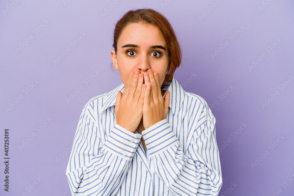 Young arab mixed race woman shocked, covering mouth with hands, anxious to discover something new. Young arab mixed race woman shocked, covering mouth with hands, anxious to discover something new.