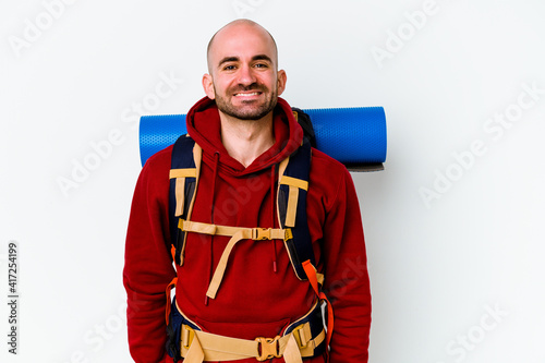 Young caucasian backpacker bald man isolated on white background happy, smiling and cheerful.