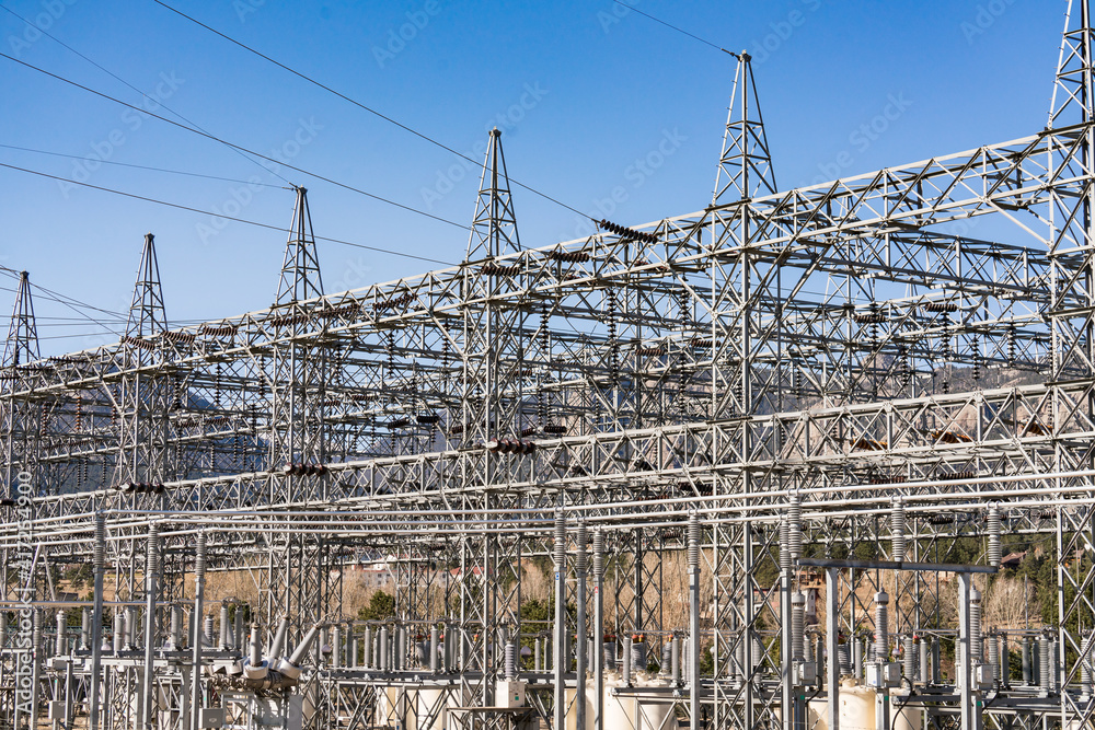 Electrical generation station with mountains in the background Electrical generation station with mountains in the background