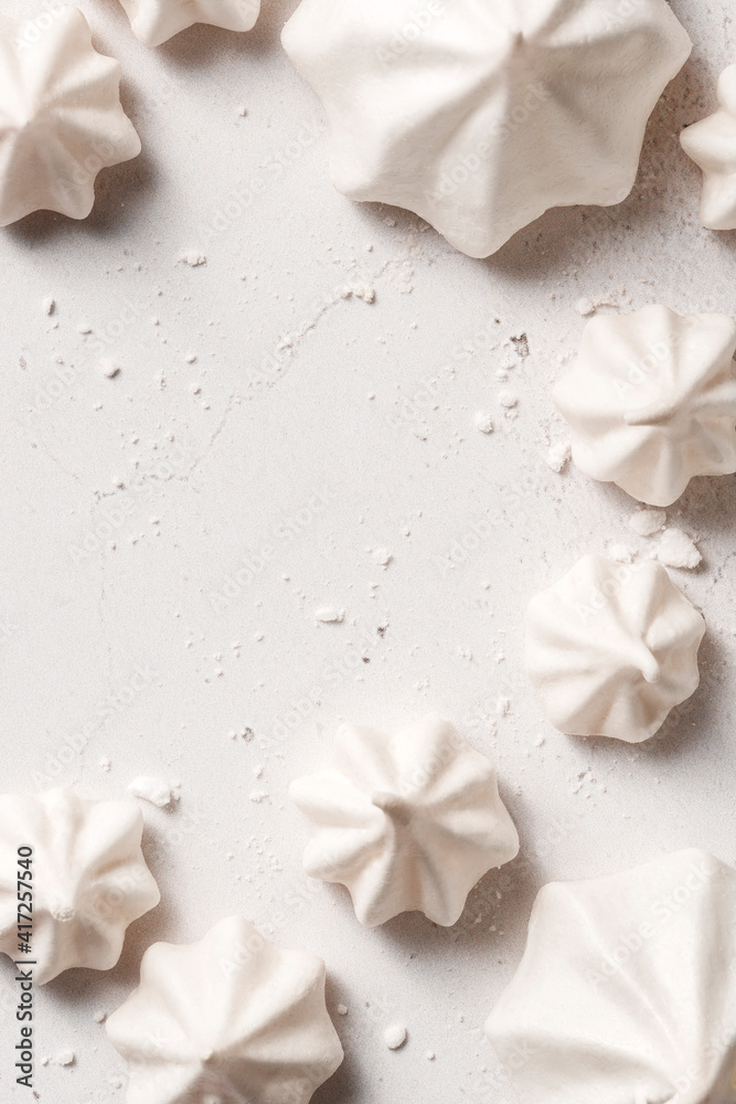 Meringues of different shapes, placed on a white background with negative space for text. Meringues of different shapes, placed on a white background with negative space for text.