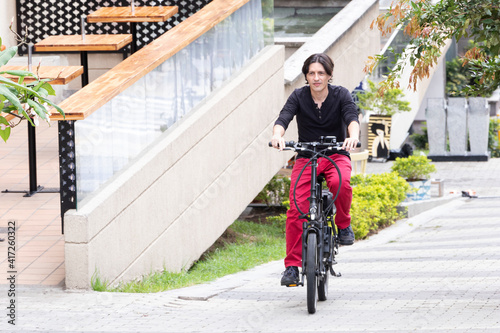 Man on electric bicycle going up hill in medellin