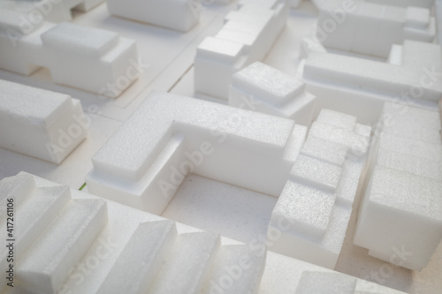 Selective focus, white architectural models. Architect's design thinking process. Urban planning model. Architecture studio working area on table.