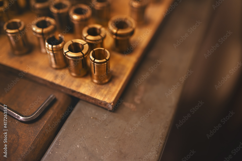 Shallow depth of field photo of goldsmith copper holders - clamp tool used to hold rings when fazeting, milling or engraving. Shallow depth of field photo of goldsmith copper holders - clamp tool used to hold rings when fazeting, milling or engraving.
