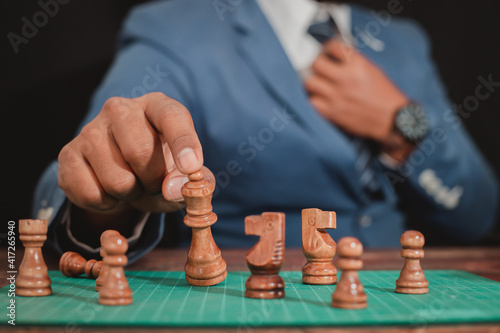 The concept of placing the game Business people use chess to plan competitive games or make successful business investments. Management strategy concept