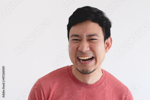 Enjoy and laughing face of Asian man in red t-shirt on isolated background.