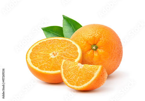 Orange  with cut in half and green leaves isolated on white background. photo