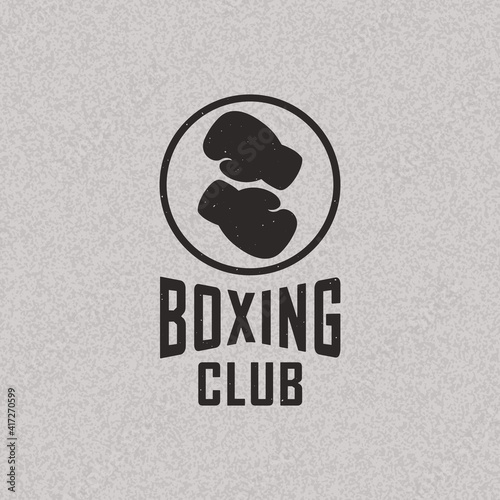 Colored illustration of boxing gloves, circle, text on textured background. Vector illustration in vintage style for emblem, label, badge. Boxing club.