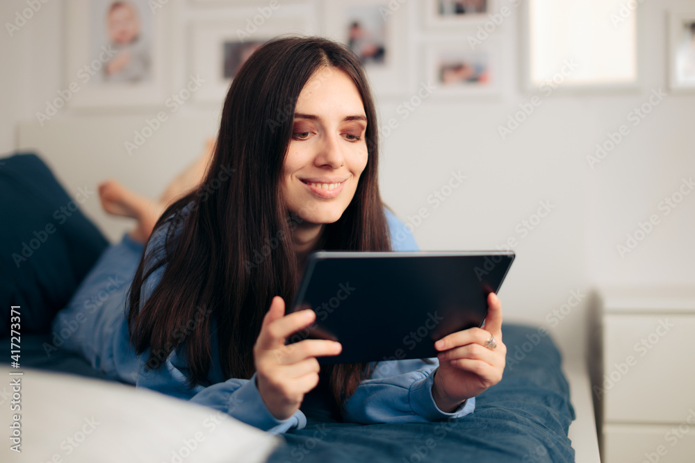 Happy Woman Holding Tablet Relaxing at Home Happy Woman Holding Tablet Relaxing at Home