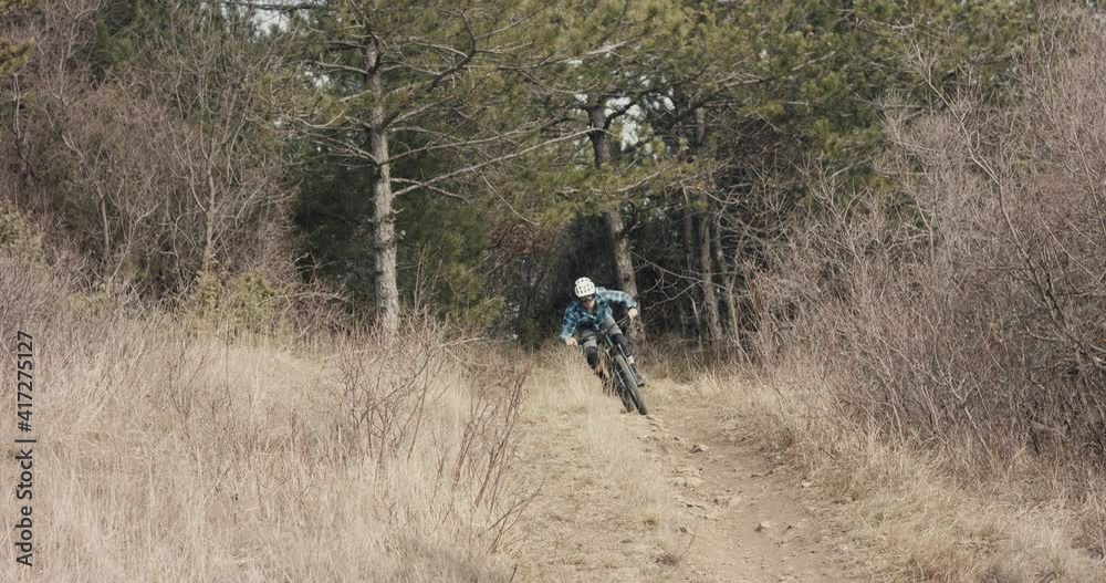 Mountain biker cyclist ride mtb bike forest trail jump turn rocks fly Mountain biker cyclist ride mtb bike forest trail jump turn rocks fly