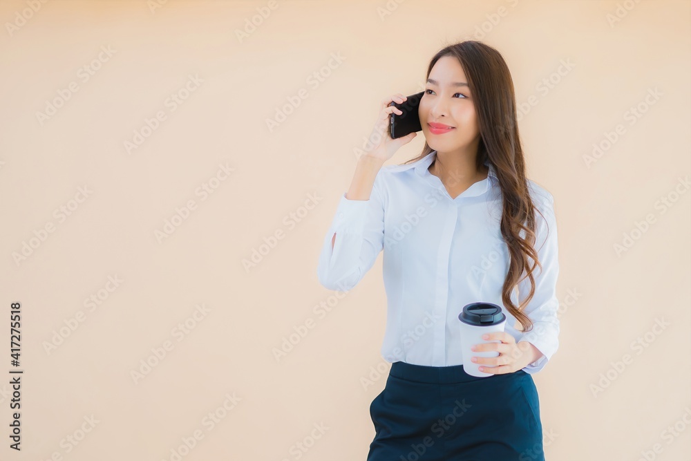 Portrait beautiful young business asian woman with smart mobile phone and coffee Portrait beautiful young business asian woman with smart mobile phone and coffee