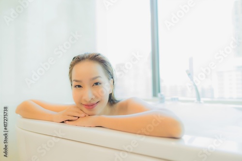 Portrait beautiful young asian woman relax in bathtub interior of bathroom