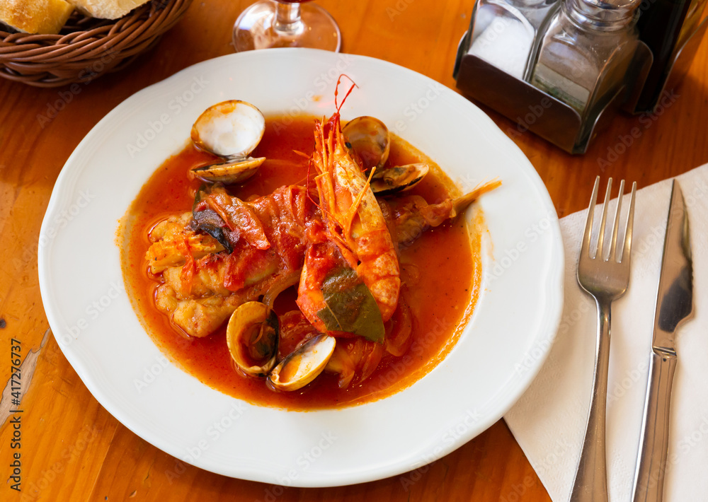 Monkfish tail in spicy sauce with shrimp and mussels. High quality photo
