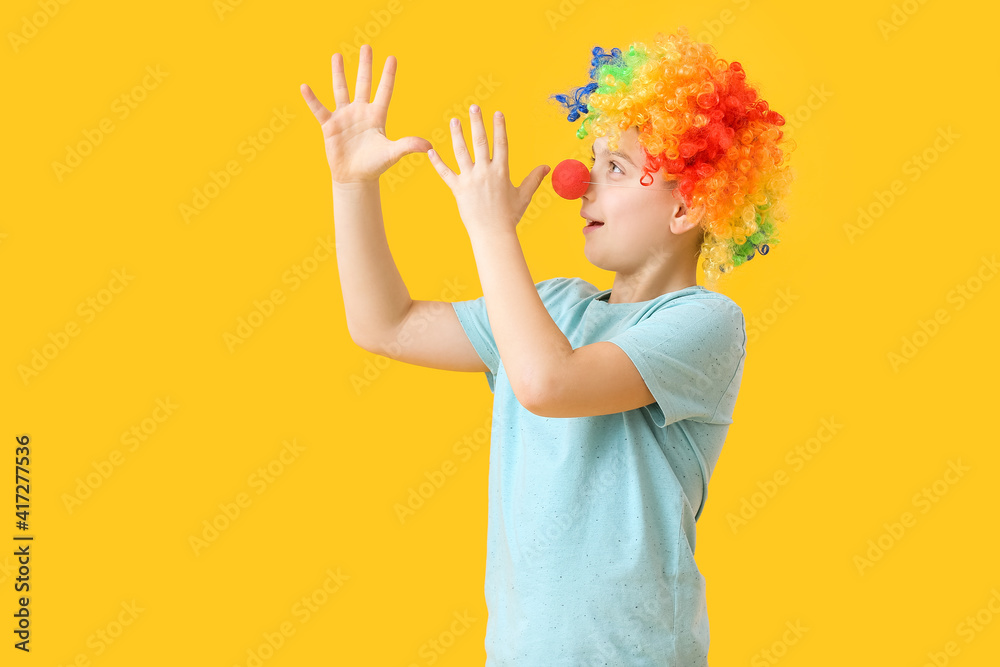Little boy in funny disguise on color background. April Fools Day celebration Little boy in funny disguise on color background. April Fools Day celebration