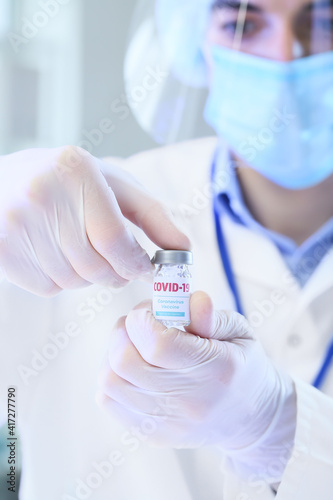 Scientist with vaccine against COVID-19 in laboratory