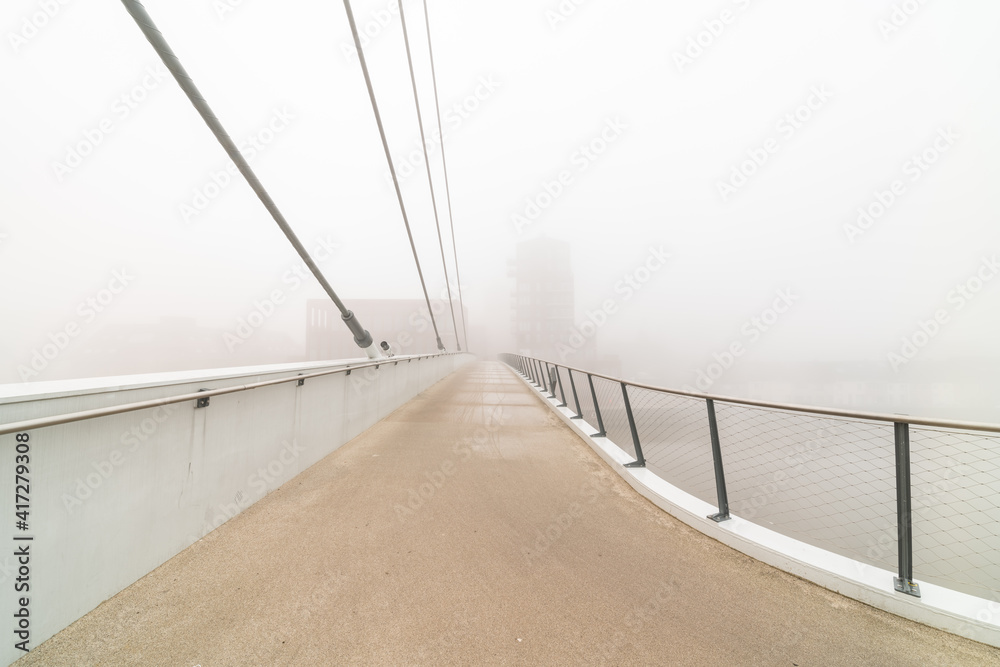 Fototapeta premium bicycle pedestrian bridge with fog