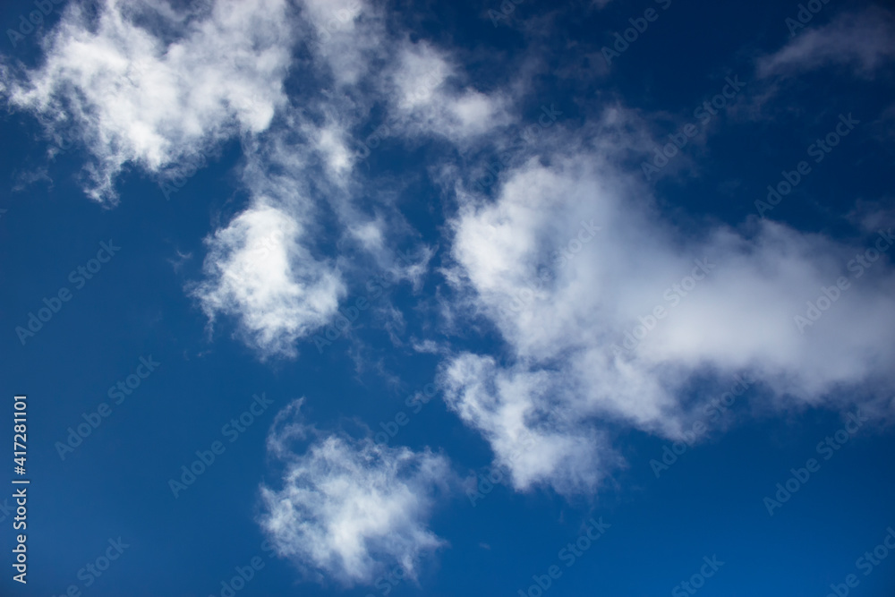 White clouds on a background of blue sky. Summer cloudy day. White clouds on a background of blue sky. Summer cloudy day.